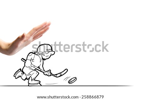 Close up of human hand and caricature of funny hockey player