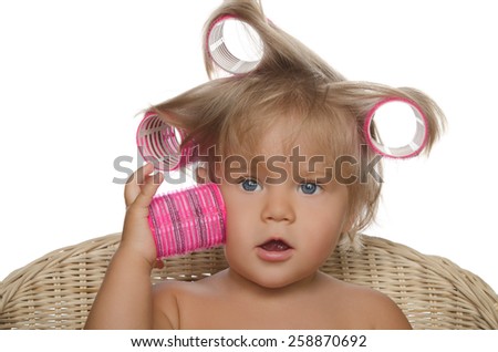 Little beautiful girl with hair curlers isolated on white