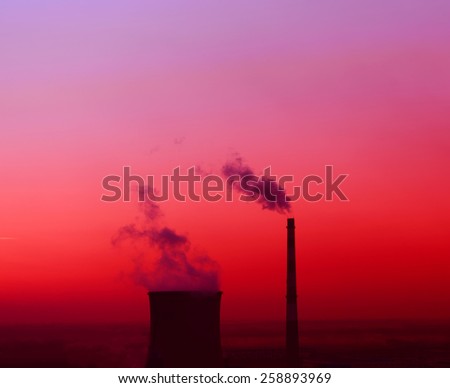 Modern thermal power plant under the setting sun 