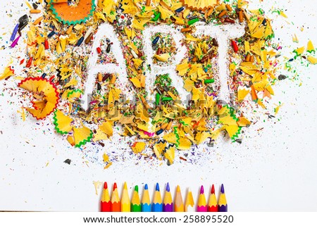 word Art over a shavings of colored pencils for drawing with copy space