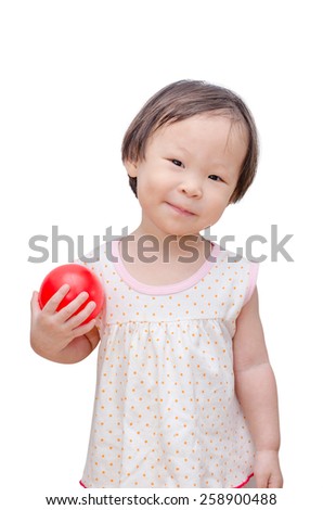 Little asian girl holding red ball over white background