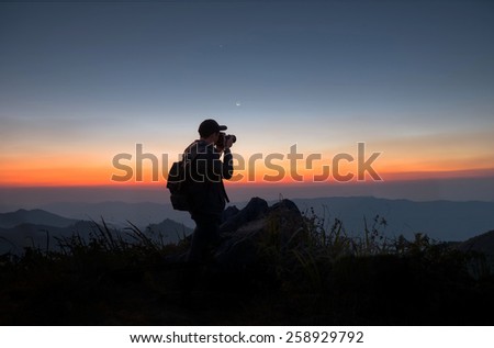professional photographer man take a photo by DSLR camera, hipster style backpacker man creative photo taking picture sunset city on a mountain in countryside Thailand, photography by digital, Asian