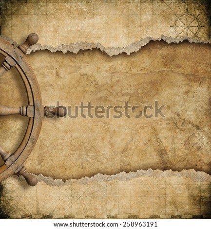 steering wheel and torn vintage nautical map 