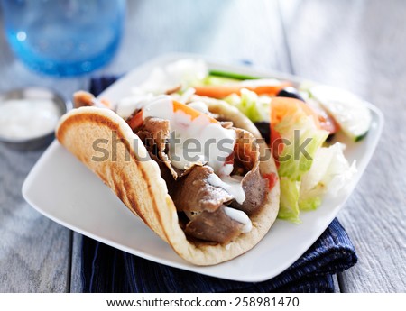 gyro with greek salad and tzatziki sauce Royalty-Free Stock Photo #258981470