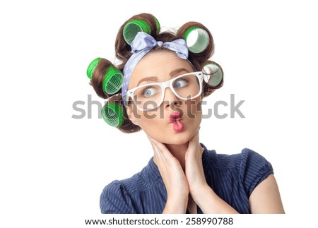 Funny woman with curlers make grimace. Bizzare girl isolated on white background, studio-shot