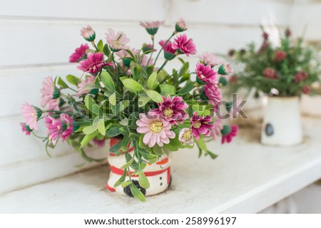 Artificial flowers in the basket in vintage theme