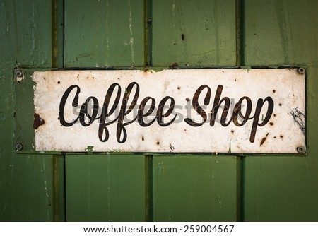 Rustic Retro Coffee Shop Sign On A Green Wooden Storefront