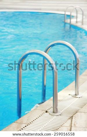 a steps in a blue water pool