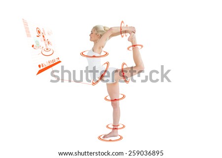 Sporty woman stretching body while balancing on one leg against fitness interface