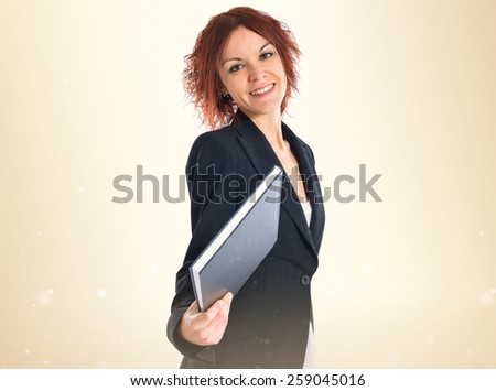 Redhead girl giving a book