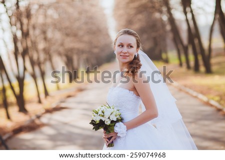 Beautiful bride outdoors in a park
