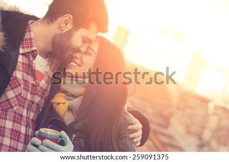 Couple loving each other outdoors on a coffee break. Royalty-Free Stock Photo #259091375