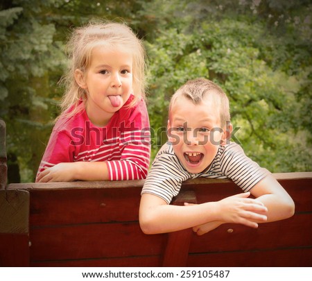 Funny kids enjoying holidays on countryside. Retro style picture
