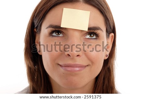 Stock photo of a young pretty woman with a post-it note on her forehead