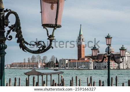 Church of San Giorgio Maggiore and ornate lampposts. View from San Marco embankment. Venice, Italy