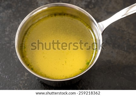 Broth in a steel pot on the stove