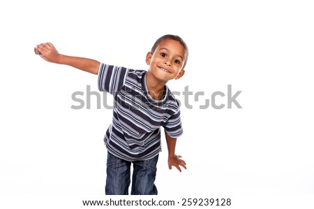 Happy black african child in studio isolated on white. Royalty-Free Stock Photo #259239128