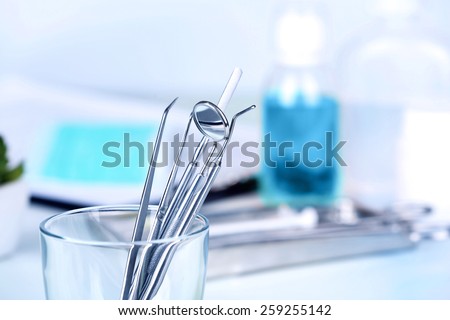 Dentist tools in glass table close up Royalty-Free Stock Photo #259255142