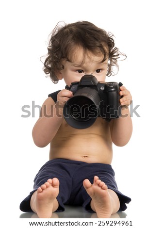 Baby with camera, isolated on a white background.
