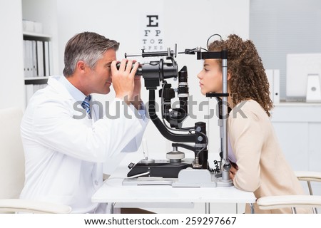 Woman doing eye test with optometrist in medical office Royalty-Free Stock Photo #259297667