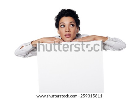 Confident african american business woman standing behind leaning at blank white banner, looking up at blank copy space, over white background