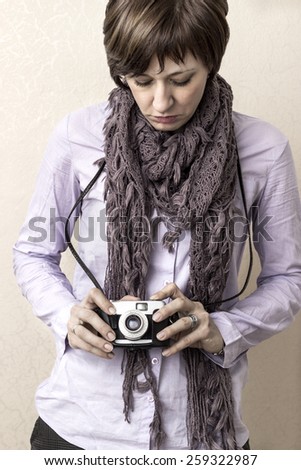 Women with old film camera in hands, close up