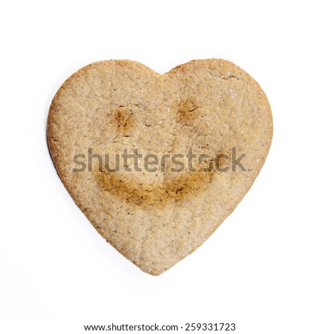 Ginger biscuits in the shape of a heart with an picture of smile: , isolated