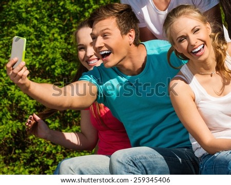 Sporty teenage friends in a park taking selfie