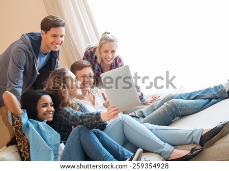 Group of young friends taking selfie in home interior 