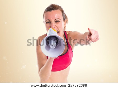 Sport woman shouting by megaphone  