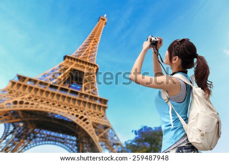 Happy travel woman in Paris with Eiffel Tower and she take a picture, asian beauty