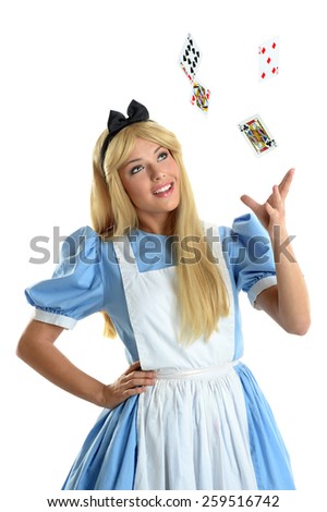 Beautiful young woman dressed in costume throwing playing cards into the air isolated over white background