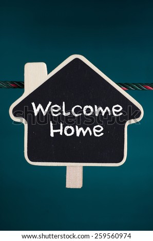 Welcome Home text on the wooden home sign