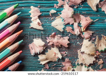 Pencils and residuals of grinding on rustic wooden background