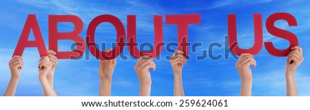 Many Caucasian People And Hands Holding Red Straight Letters Or Characters Building The English Word About Us On Blue Sky