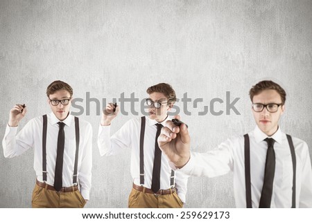 Nerdy businessman writing against white and grey background