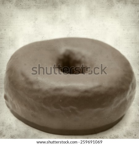 textured old paper background with chocolate glaze donut