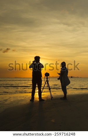 Silhouette of photographers when sunset time on the beach at Koh Samui, Thailand