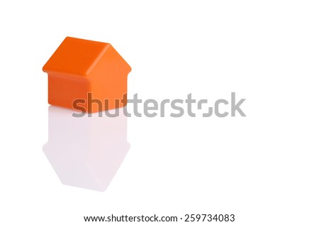 orange small plastic toy house isolated on white background