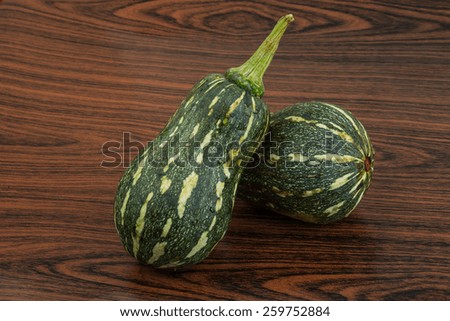 Two Green pumpkins on the wooden background