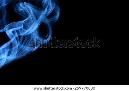 Photo of smoke creating a variety of smooth curves, spirals and flows on black background 