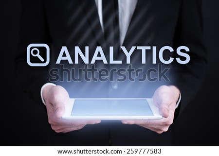 businessman holding a tablet pc with analytics text. Internet concept. business concept. 