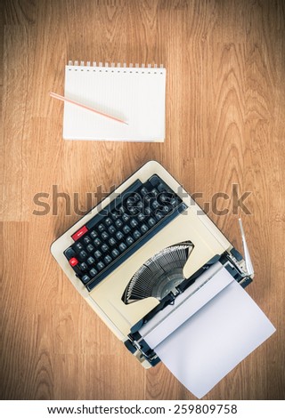 Vintage typewriter and a blank notebook of paper, retro style
