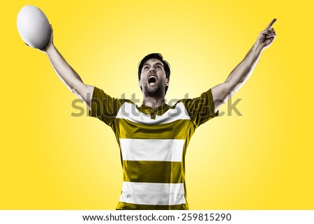 Rugby player in a yellow uniform celebrating on a yellow background.