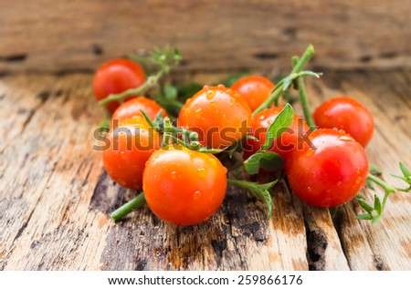 Organic tomatoes on old wooden floor
