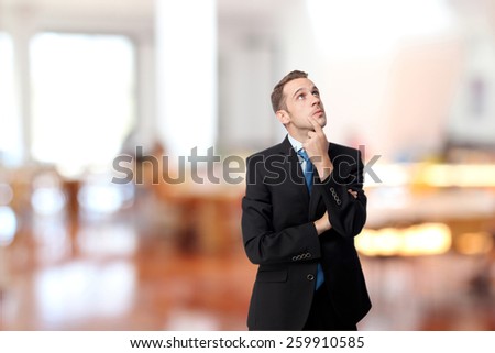 man with suit thinking in the library