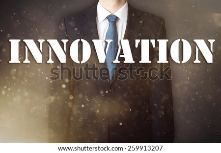 Conception of the business presented against the war background as the symbol of the continuous fight in the business. Businessman standing in dust - in the foreground is big inscription - Innovation