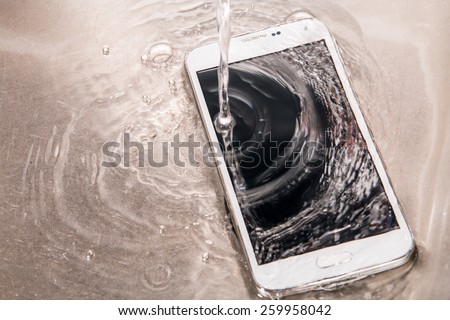 Smashed, damaged, destroyed phone, phablet by water