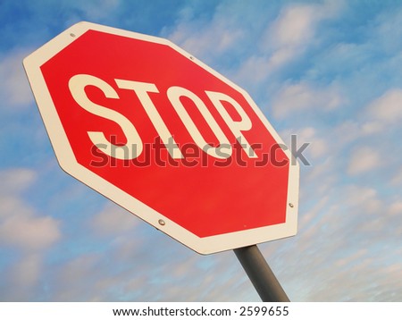 stop sign against blue light clouded sky
