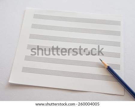 Music note sheet with pencil on white background, Selective focus on Sharpness of pencil